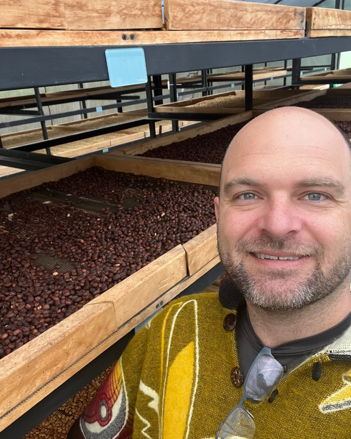 John Austin inside a multi-level coffee drying structure in Colombia